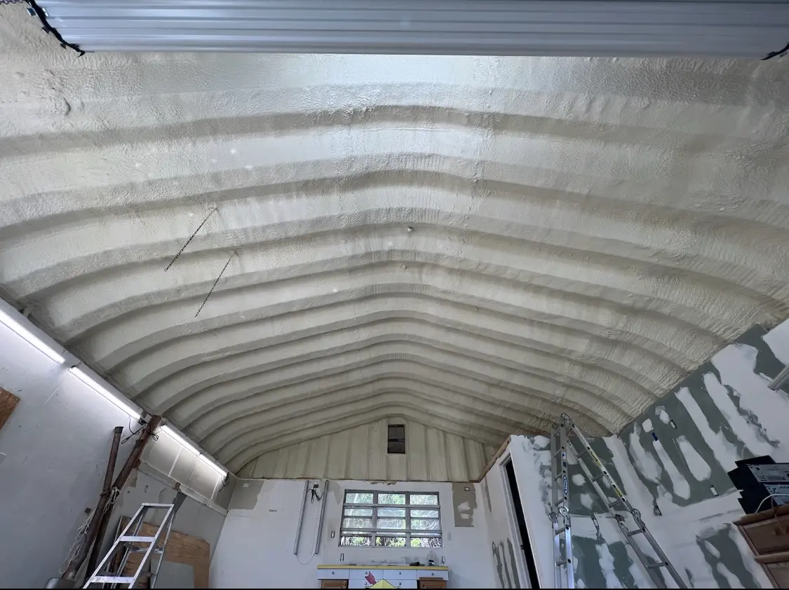 Spray polyurethane foam applied to the underside of a metal roof deck in White